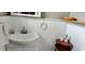 Clean bathroom with pedestal sink and wood shelving at 1628 Paradise Ln, Astor, FL 32102