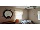 Bedroom with a large mirror and window with blinds at 1628 Paradise Ln, Astor, FL 32102
