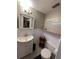 Small bathroom with toilet and pedestal sink at 1628 Paradise Ln, Astor, FL 32102