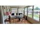Bright sunroom with wood floors, wicker chairs, and fireplace at 1628 Paradise Ln, Astor, FL 32102