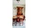 Charming dining area with a wooden table and hutch at 1628 Paradise Ln, Astor, FL 32102