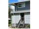 Exterior view of a building with gray siding and stairs at 2329 River Ridge Rd # 160, Deland, FL 32720