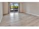 Spacious living room with wood-look floors and access to a screened balcony at 2329 River Ridge Rd # 160, Deland, FL 32720