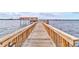 Community wooden dock extending into the water at 2801 N Halifax Ave # 143, Daytona Beach, FL 32118