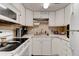 Bright kitchen boasts white cabinets, modern appliances, and ample counter space at 2801 N Halifax Ave # 143, Daytona Beach, FL 32118