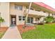 Ground-level condo with private patio, lush landscaping, and walkway access at 2801 N Halifax Ave # 143, Daytona Beach, FL 32118
