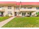 Ground level condo with private patio, lush landscaping, and walkway access at 2801 N Halifax Ave # 143, Daytona Beach, FL 32118