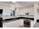 White kitchen with granite countertops and stainless steel appliances at 138 Old Carriage Rd, Ponce Inlet, FL 32127