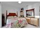 Bedroom with floral bedding and wooden furniture at 138 Old Carriage Rd, Ponce Inlet, FL 32127