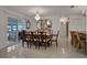 Elegant dining room with a large wooden table and crystal chandelier at 138 Old Carriage Rd, Ponce Inlet, FL 32127