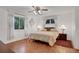 Large bedroom with a king-size bed, ceiling fan, and hardwood floors at 138 Old Carriage Rd, Ponce Inlet, FL 32127