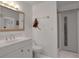 Bright bathroom with white vanity, toilet and shower at 138 Old Carriage Rd, Ponce Inlet, FL 32127