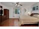 King-size bed, wood dresser, and hardwood floors at 138 Old Carriage Rd, Ponce Inlet, FL 32127