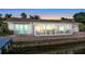 Waterfront home with sunroom and brick patio at sunset at 138 Old Carriage Rd, Ponce Inlet, FL 32127