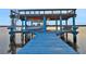 Covered boat lift with kayak storage and a spiral staircase at 138 Old Carriage Rd, Ponce Inlet, FL 32127