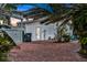 Brick paved backyard with lush tropical landscaping at 138 Old Carriage Rd, Ponce Inlet, FL 32127