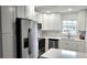Renovated kitchen, featuring white cabinets and stainless steel appliances at 217 N Hill Ave # 20, Deland, FL 32724