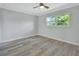 Spacious bedroom with wood-look flooring and large window at 217 N Hill Ave # 20, Deland, FL 32724