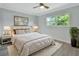 Main bedroom with plush bed, stylish lamps, and large window at 217 N Hill Ave # 20, Deland, FL 32724