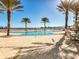 Resort-style pool with ample deck space and palm trees at 241 Riverside Dr # 2205, Holly Hill, FL 32117