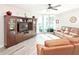 Living room with hardwood floors, leather sofas, and large TV at 241 Riverside Dr # 2205, Holly Hill, FL 32117