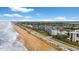 Aerial view of beachfront property, showcasing building and ocean at 2700 Ocean Shore Blvd # 111, Ormond Beach, FL 32176