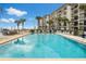 Relaxing community pool with plenty of lounge chairs for sunbathing at 2700 Ocean Shore Blvd # 111, Ormond Beach, FL 32176
