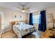 Bedroom with a queen bed, ceiling fan, and ocean-themed decor at 2700 Ocean Shore Blvd # 111, Ormond Beach, FL 32176