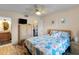 Primary bedroom with a queen bed, ceiling fan and access to the bathroom at 2700 Ocean Shore Blvd # 111, Ormond Beach, FL 32176