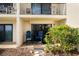 Ground level patio with two blue chairs and tropical plants at 2700 Ocean Shore Blvd # 111, Ormond Beach, FL 32176