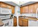 Well-equipped kitchen with wood cabinets, stainless steel appliances, and double sink at 2700 Ocean Shore Blvd # 111, Ormond Beach, FL 32176