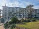 Three-story building with pool and landscaping at 2700 Ocean Shore Blvd # 111, Ormond Beach, FL 32176
