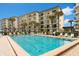 Inviting community pool with lounge chairs, ready for relaxation at 2700 Ocean Shore Blvd # 111, Ormond Beach, FL 32176