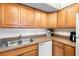 Full view of the kitchen, featuring wood cabinets and appliances at 2700 Ocean Shore Blvd # 111, Ormond Beach, FL 32176