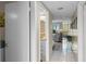 Clean hallway with tiled floor and partial view of the bathroom at 2700 Ocean Shore Blvd # 111, Ormond Beach, FL 32176