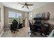 Spacious home office with two desks, ample natural light, and hardwood floors at 4672 Riverwalk Village Ct # 8201, Ponce Inlet, FL 32127