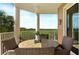 Spacious balcony with a wooden table and chairs, offering tranquil views at 4672 Riverwalk Village Ct # 8201, Ponce Inlet, FL 32127