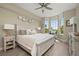 Bright bedroom with king-size bed, bay window, and ceiling fan at 4672 Riverwalk Village Ct # 8201, Ponce Inlet, FL 32127