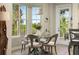 Bright dining area with glass table and chairs, overlooking scenic views at 4672 Riverwalk Village Ct # 8201, Ponce Inlet, FL 32127