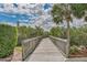 Wooden boardwalk path through lush tropical landscaping at 4672 Riverwalk Village Ct # 8201, Ponce Inlet, FL 32127