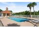 Community pool with lounge chairs and a gazebo at 4672 Riverwalk Village Ct # 8201, Ponce Inlet, FL 32127