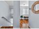 Upstairs hallway with hardwood floors and natural light at 4111 S Atlantic Ave, Port Orange, FL 32127