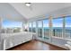 Main bedroom with ocean views, hardwood floors and sliding doors to balcony at 4111 S Atlantic Ave, Port Orange, FL 32127