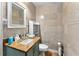 Small bathroom with teal vanity and granite countertop at 4111 S Atlantic Ave, Port Orange, FL 32127
