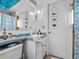 Clean bathroom with light blue vanity and updated fixtures at 3580 Ocean Shore Blvd, Ormond Beach, FL 32176