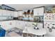 Modern kitchen with white cabinets, granite countertops, and breakfast bar at 3580 Ocean Shore Blvd, Ormond Beach, FL 32176