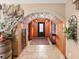 View of the entryway, highlighting the arched entryway and wood and tile flooring at 3580 Ocean Shore Blvd, Ormond Beach, FL 32176