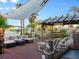 Covered Tiki bar on a spacious deck with comfortable seating and a shade sail at 3580 Ocean Shore Blvd, Ormond Beach, FL 32176