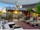 Spacious deck with tiki bar, lounge chairs, and a shade sail offering a relaxing space at 3580 Ocean Shore Blvd, Ormond Beach, FL 32176