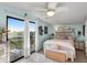 Main bedroom with king-size bed and access to a private balcony at 3580 Ocean Shore Blvd, Ormond Beach, FL 32176